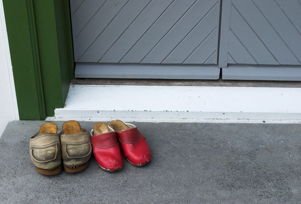 Pair of clogs left outside cabin door. Via Shutterstock