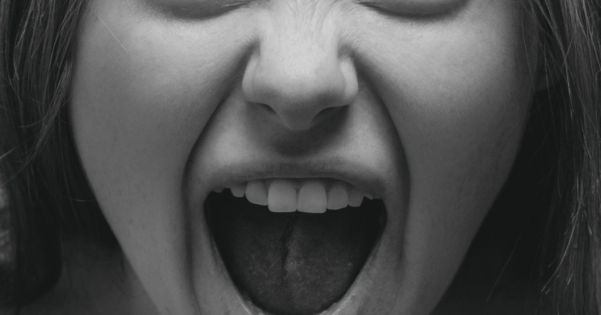 Dramatic grayscale portrait capturing a woman's intense facial expression in Kyiv.