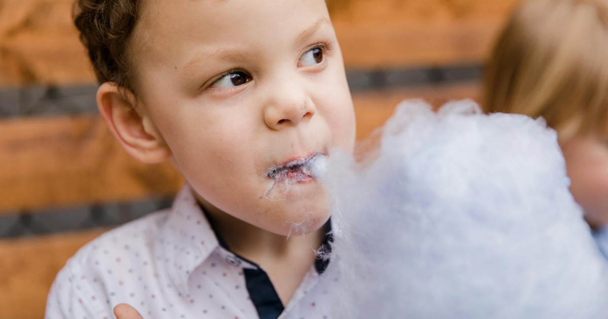 A child delighting in cotton candy, capturing a playful and sweet moment.