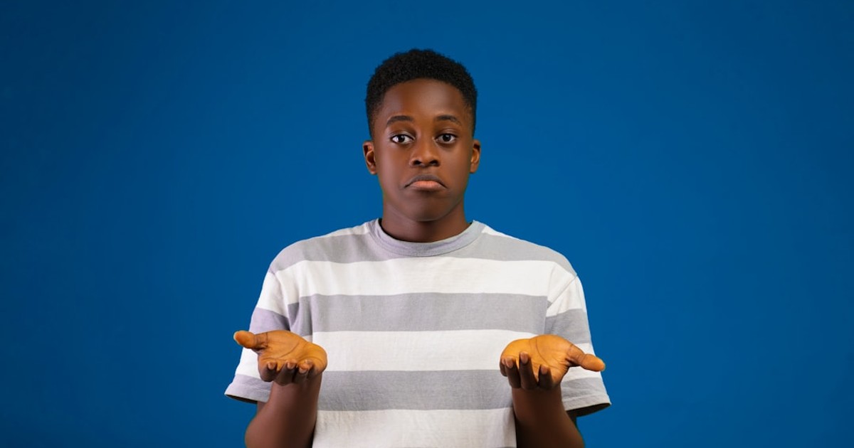 a boy with his arms crossed