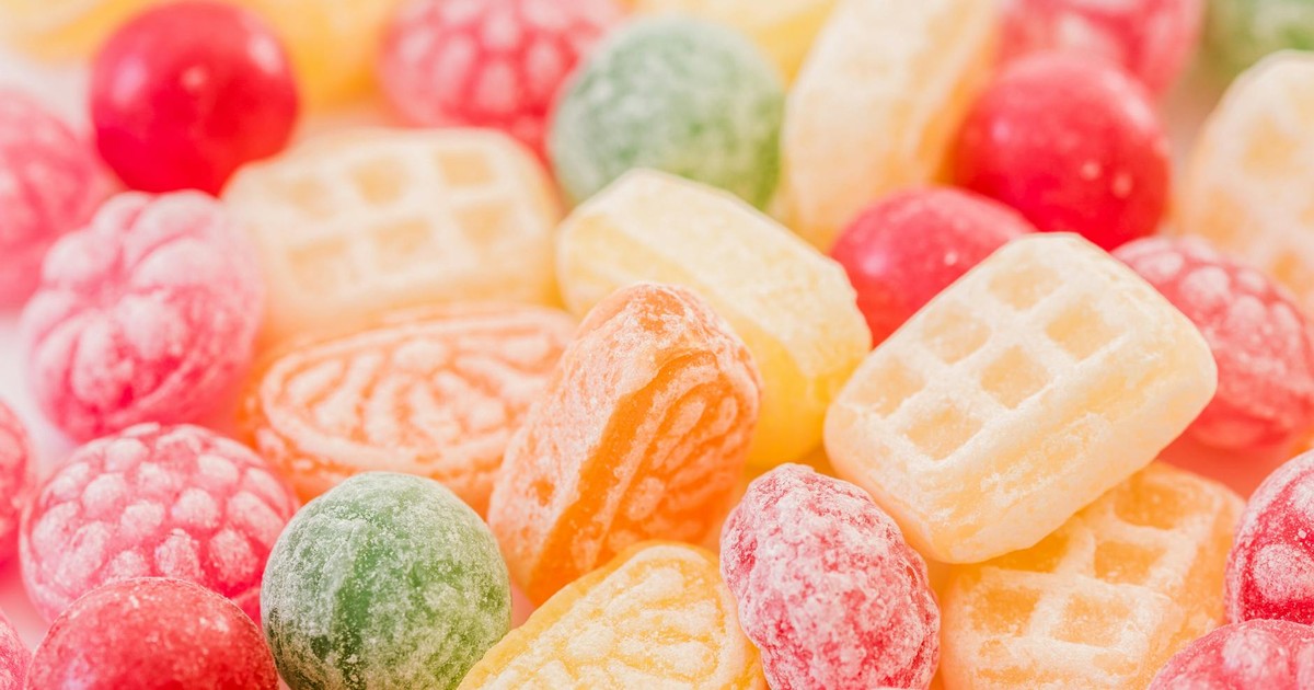 A close-up view of assorted colorful hard candies with various shapes and colors.