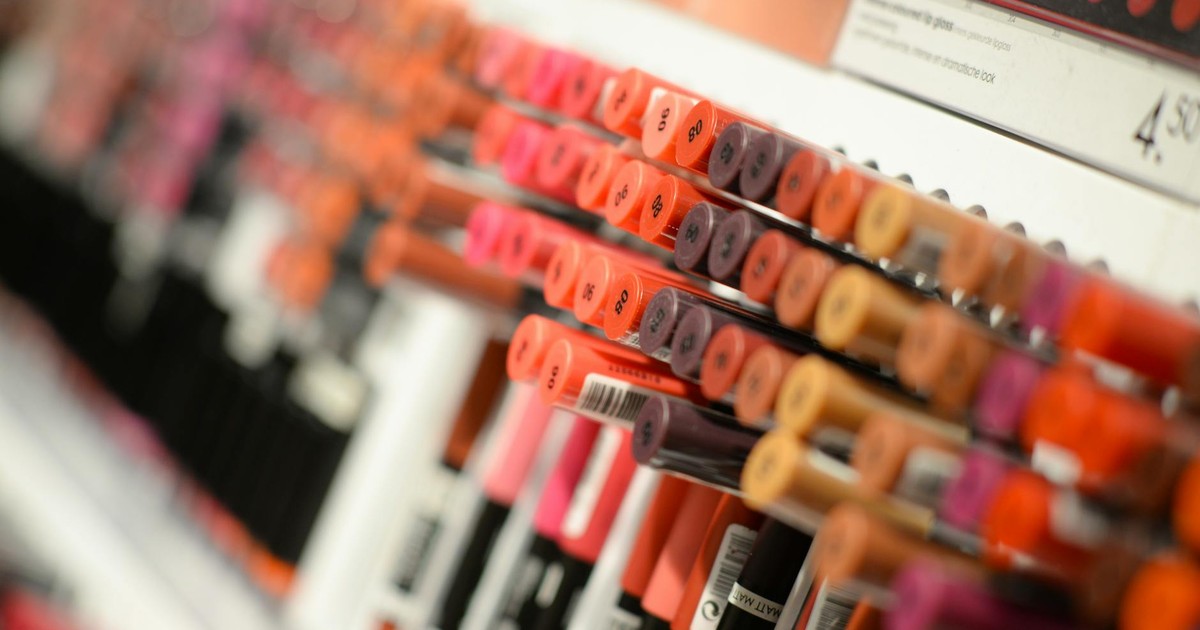 Close-up of diverse lipsticks in a store showcasing various shades and brands for beauty enthusiasts.