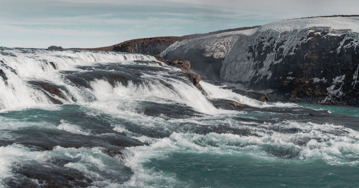 Discover the dramatic beauty of an Icelandic waterfall cascading powerfully over icy rocks.