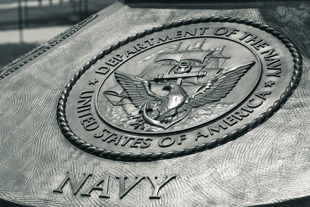 Detailed view of the United States Navy emblem on a monument in Washington D.C., showcasing naval heritage