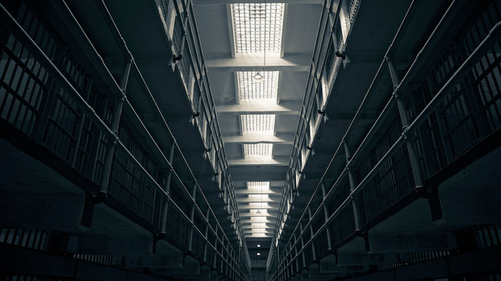 A low-angle view of Alcatraz prison cell block, showcasing steel railings