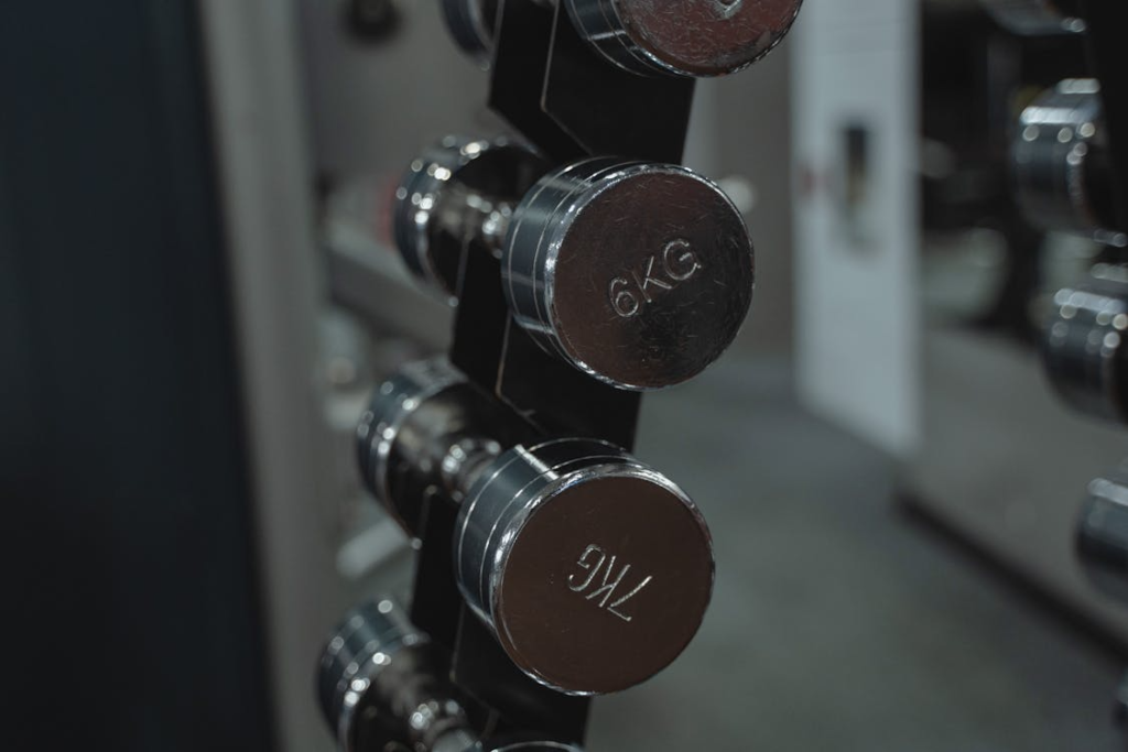 Metal dumbbells neatly arranged in a gym setting, kilogram metric measurement