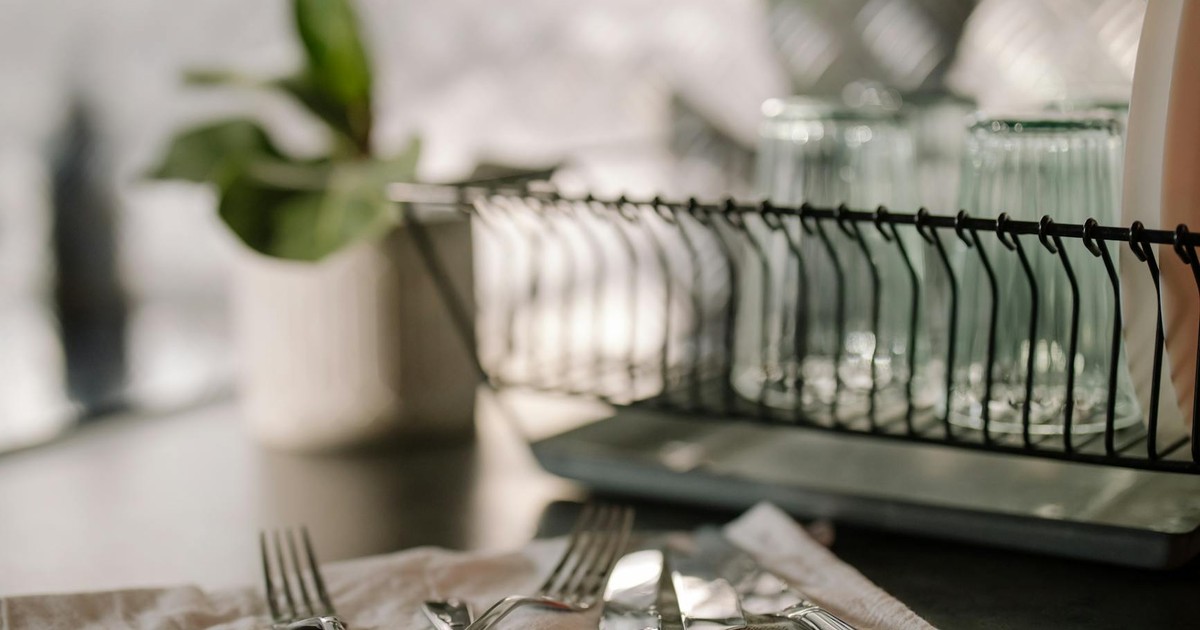 A beautifully arranged kitchen scene featuring cutlery, glasses, and modern kitchenware.