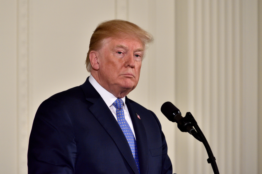 WASHINGTON, DC - APRIL 27, 2018: President Donald Trump pauses as he speaks at a joint press conference with German Chancellor Angela Merkel in the East Room of the White House.