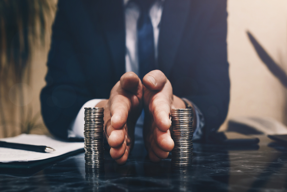 Businessman separates stack coins. Concept of  saving and investing.  Property division. Divorce and legal services.