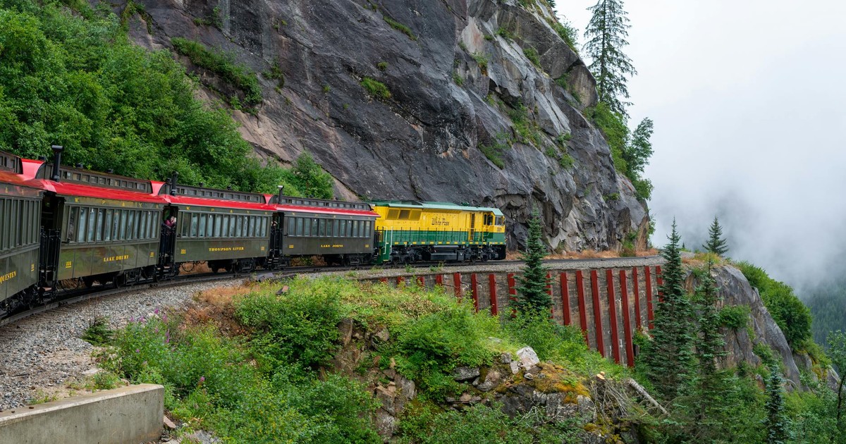 Dramatic view of a train traversing the scenic White Pass and Yukon Route near Skagway, Alaska.