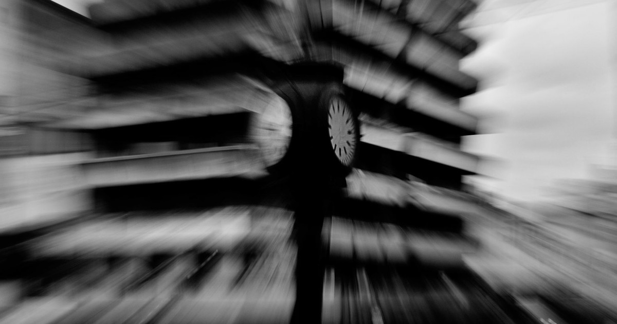 Creative black and white motion blur photo of a street clock in La Plata, Argentina.
