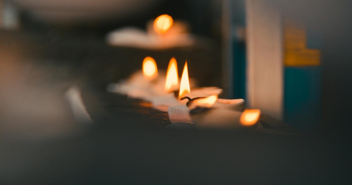 Close-up of flickering candle flames creating a warm atmosphere.