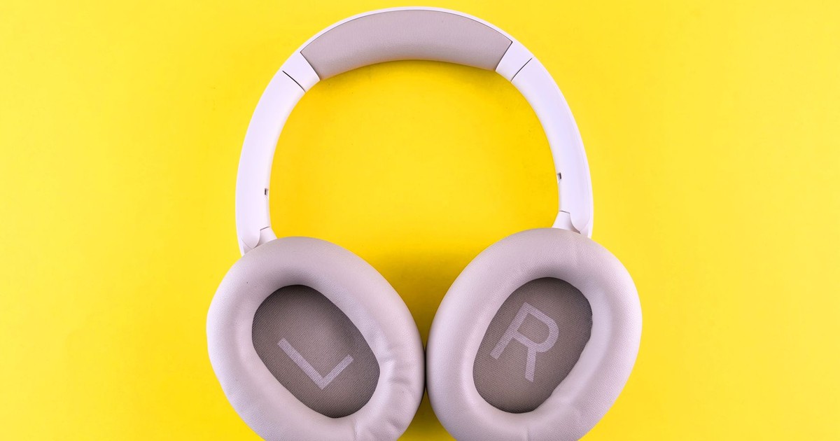 Stylish wireless headphones placed on a bold yellow surface, showcasing modern design and comfort.