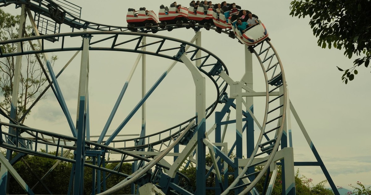Thrilling roller coaster ride in an outdoor amusement park setting during the day.