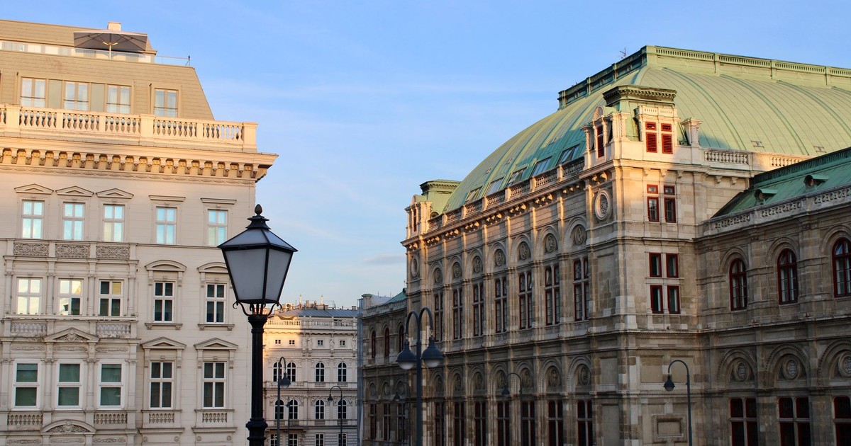 Beautiful historic buildings with classic architecture under a clear blue sky in Vienna.