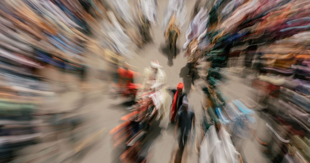 Zoom blur effect capturing a diverse crowd at an outdoor event, creating a sense of motion and energy.