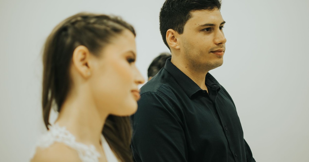 A close-up profile of a bride and groom, capturing a candid moment in a modern wedding setting.