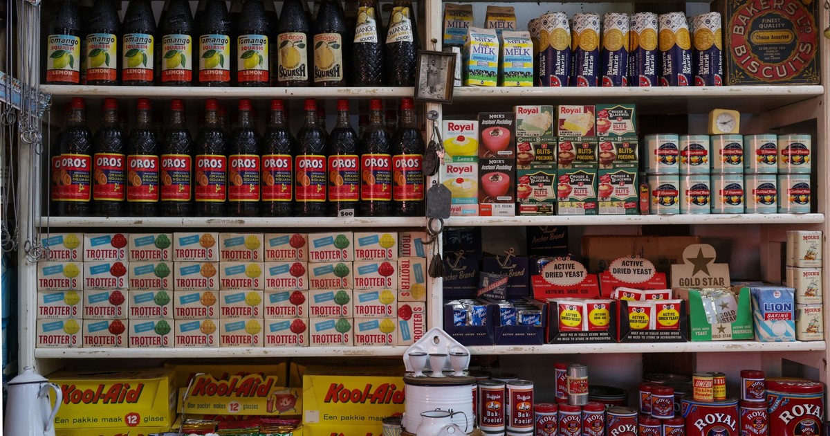 Explore a vintage grocery store shelf filled with bottles, canned goods, and more supplies.