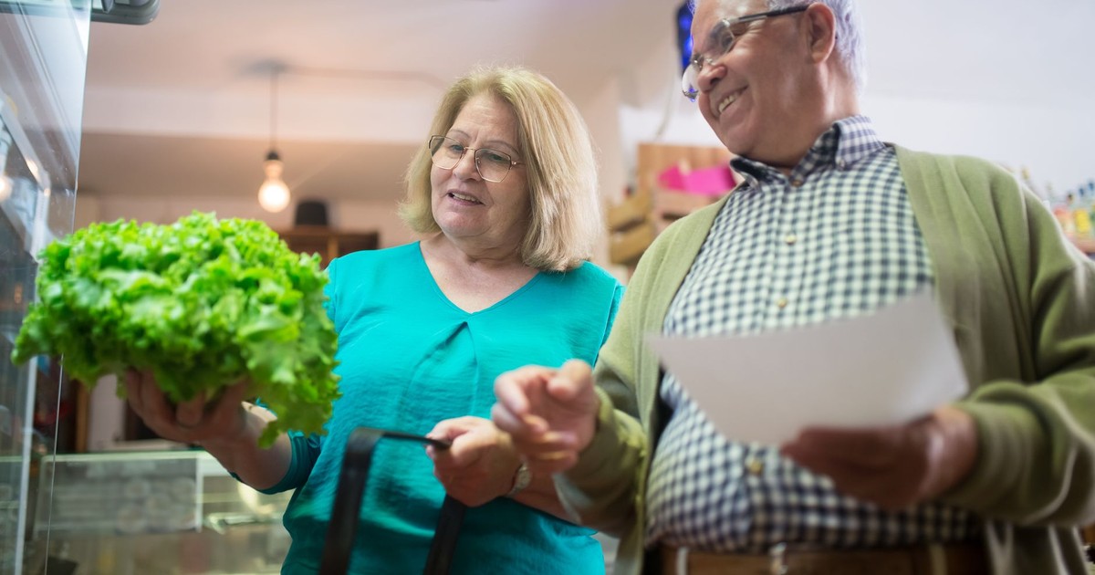 Happy senior couple shopping for fresh vegetables together, enjoying a day out.