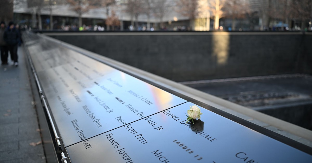 White rose on engraved names at 9/11 Memorial, poignant tribute to 9/11 victims.