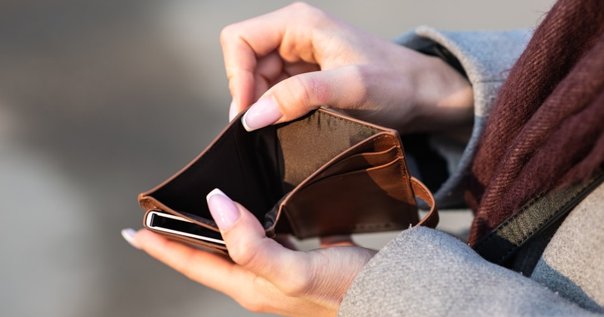 hands holding empty wallet and phone