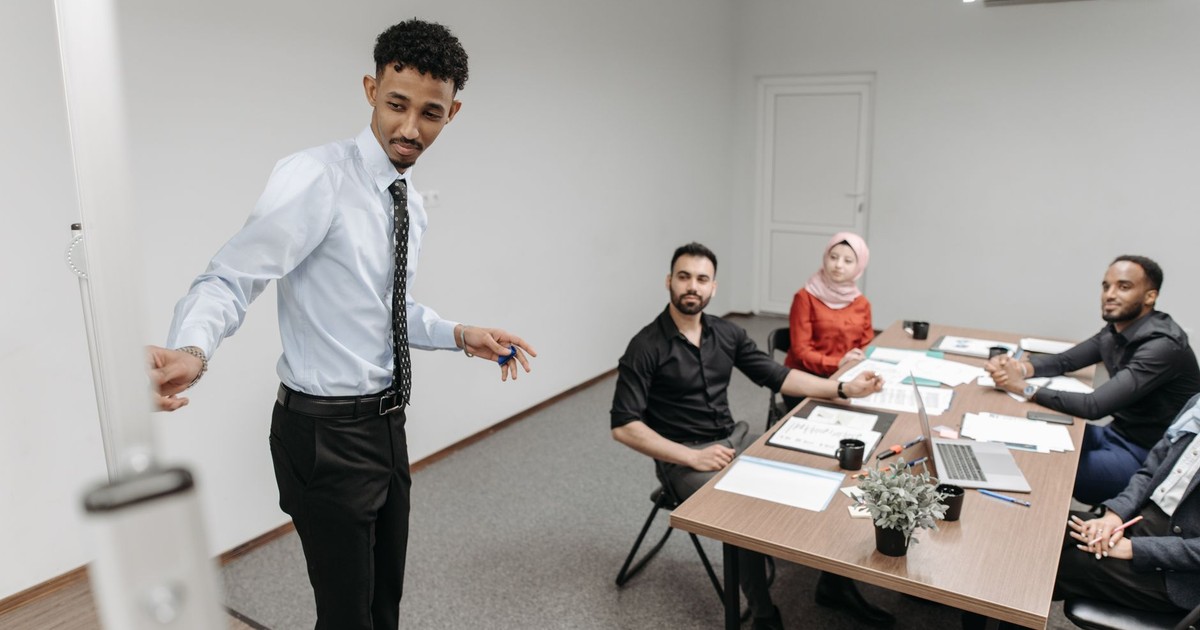 A diverse team collaborates in a modern office setting, showcasing teamwork and communication.