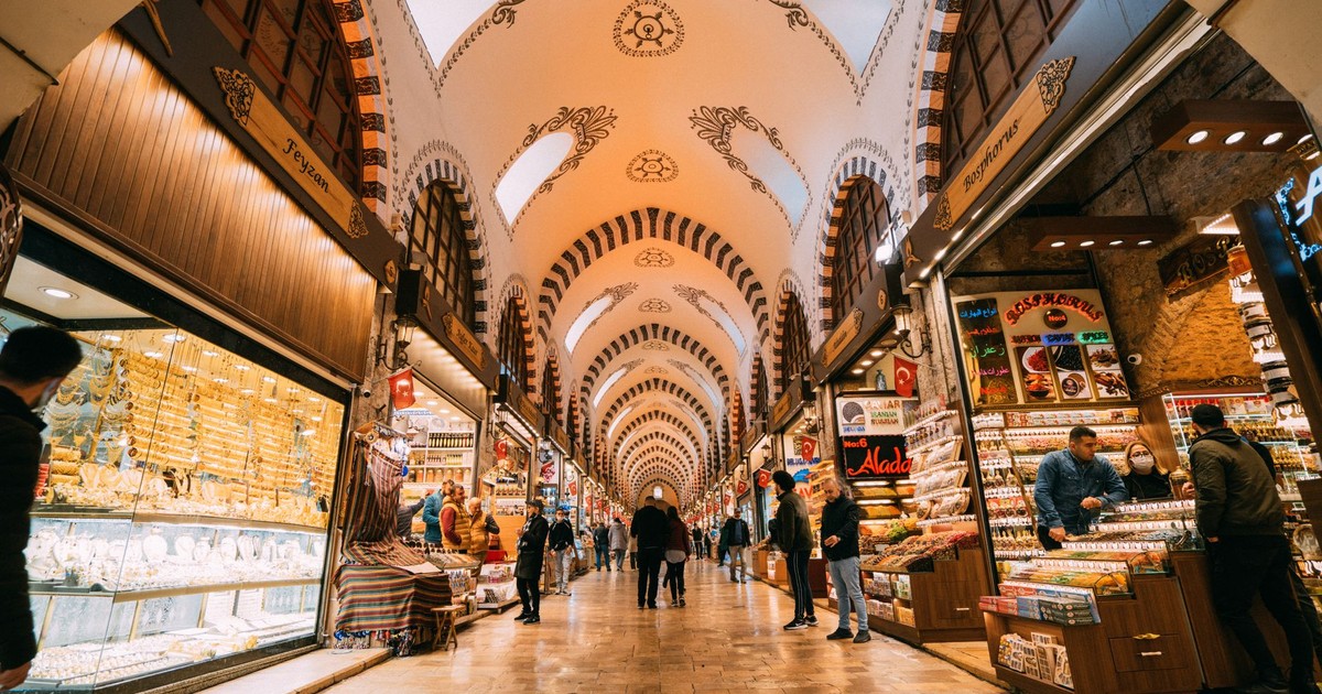 Vibrant scene inside the Grand Bazaar, filled with shops and people exploring traditional goods.
