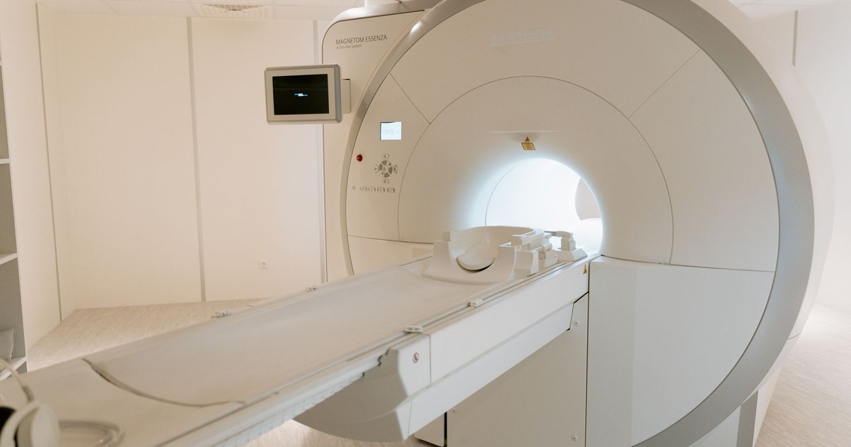 A state-of-the-art MRI scanner in a well-lit hospital room, ready for patient use.