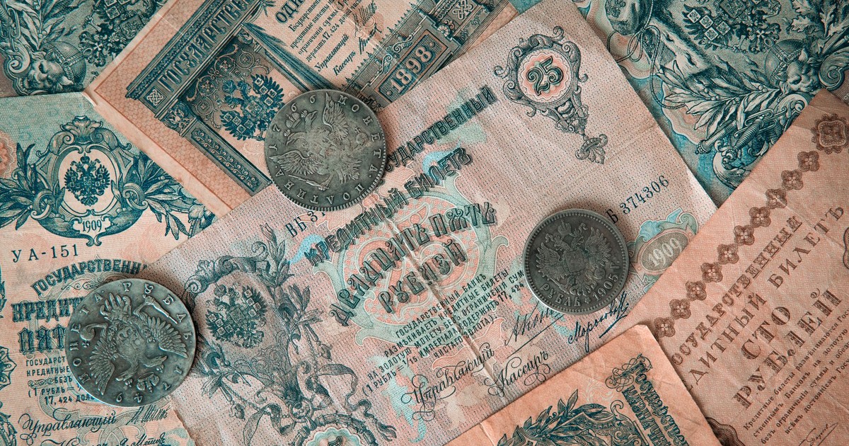 Collection of vintage Russian banknotes and coins featuring intricate designs.
