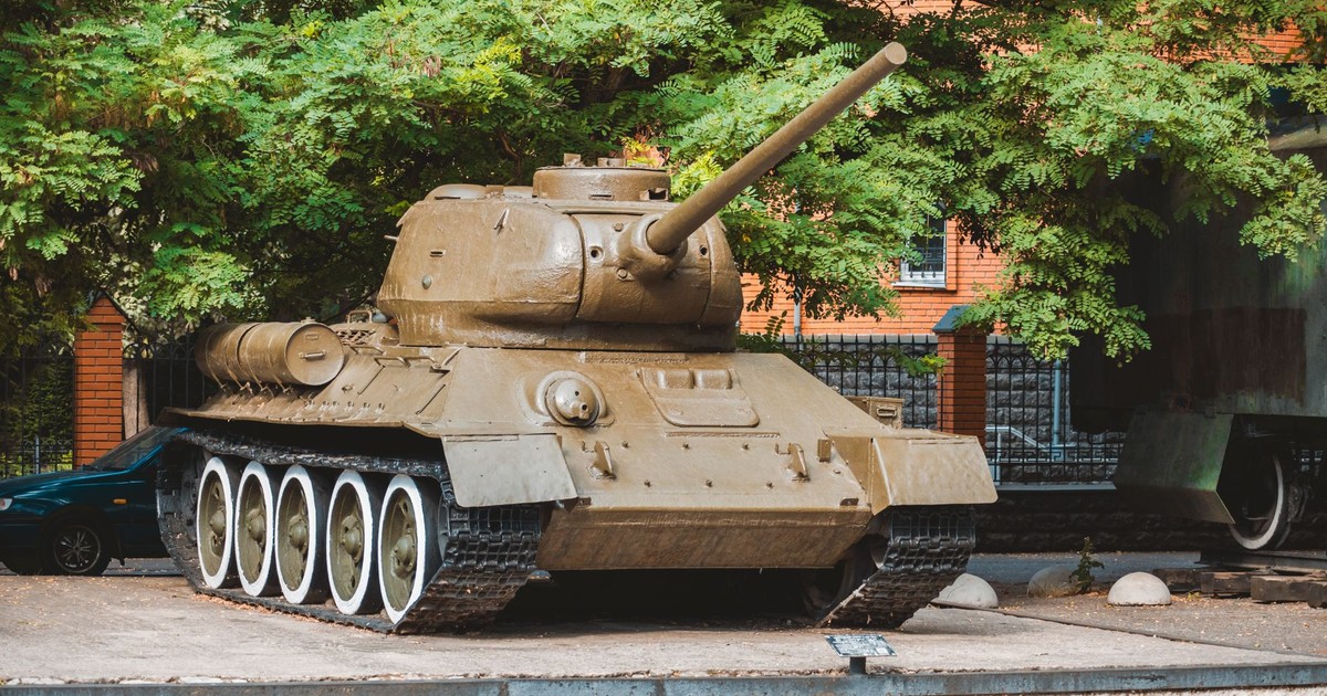 A vintage tank exhibited outdoors showcases military history and heritage.