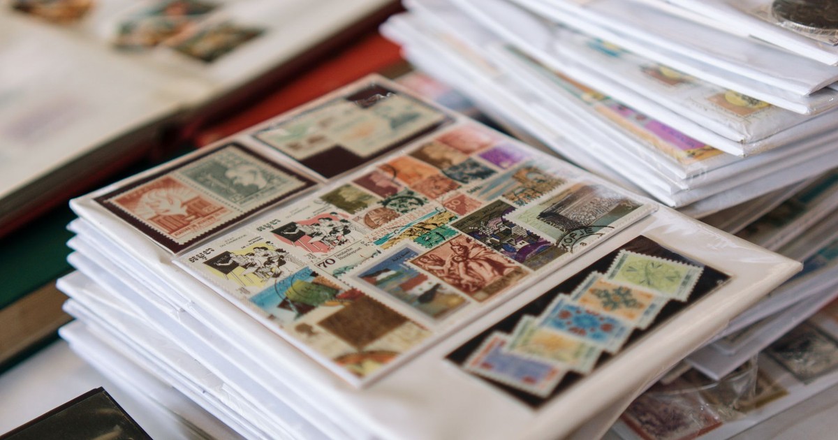 A detailed collection of vintage postage stamps neatly organized in albums, showcasing diverse themes.