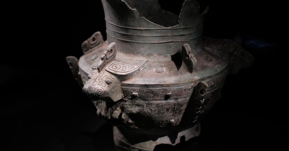 Intricate ancient Chinese bronze vessel with decorative patterns and animal motifs on display.