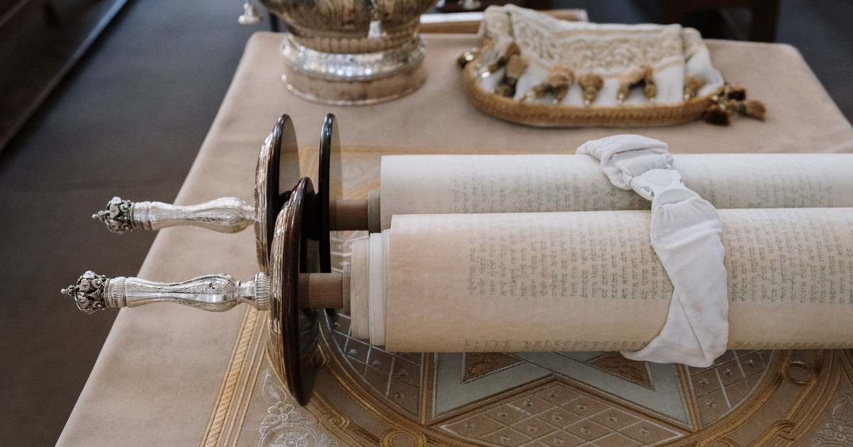 Sefer Torah scroll displayed on a bimah in a synagogue setting, showcasing rich cultural heritage.