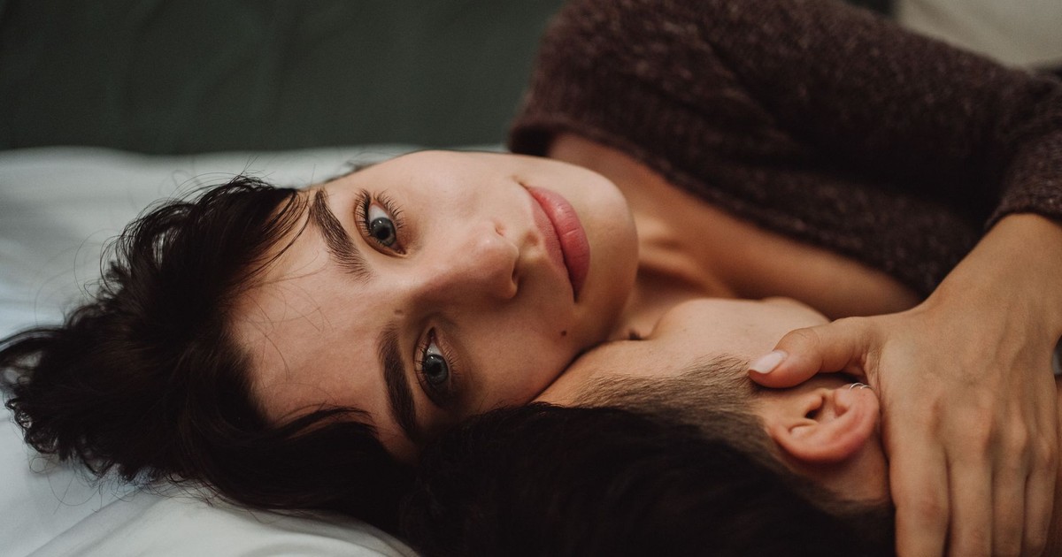 Close-up of a couple embracing, showcasing intimacy and emotional connection indoors.