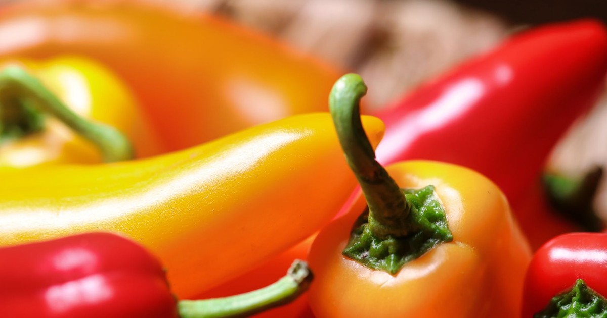 Colorful close-up of fresh red and yellow peppers, ideal for healthy cooking and nutrition.