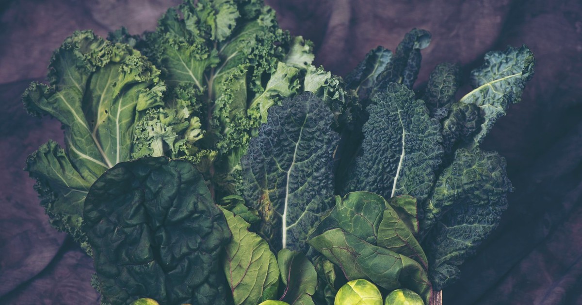 A vibrant assortment of fresh kale and Brussels sprouts showcasing healthy greens.