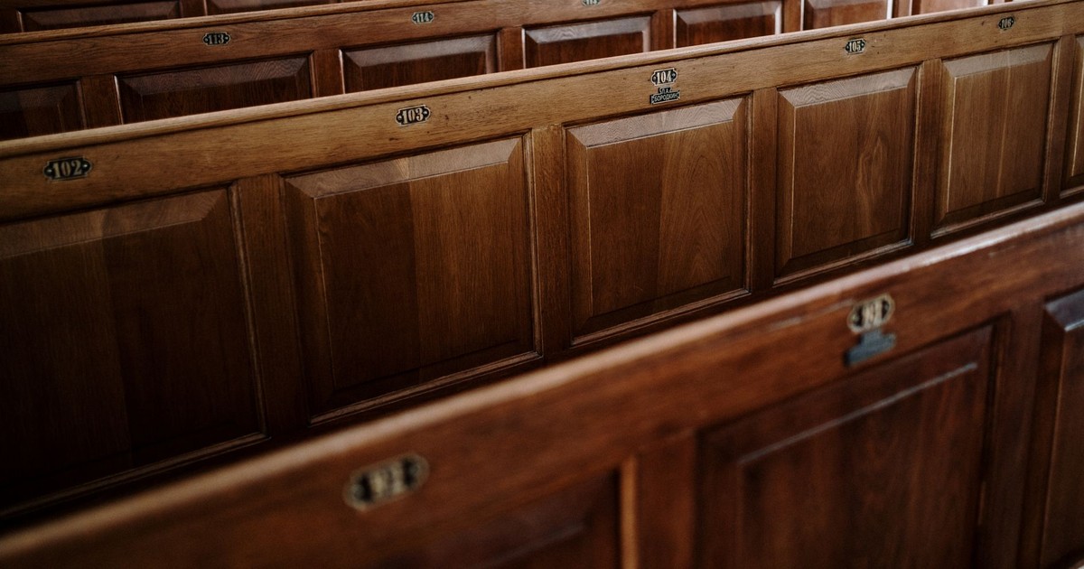 Close-up view of wooden pews inside a church, showcasing the intricate design.