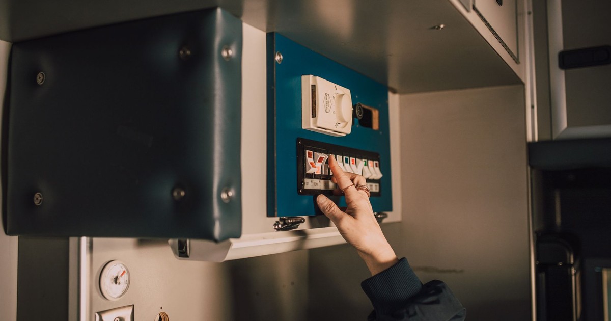 Close-up of a hand operating switches inside an ambulance. Perfect for healthcare and emergency themes.