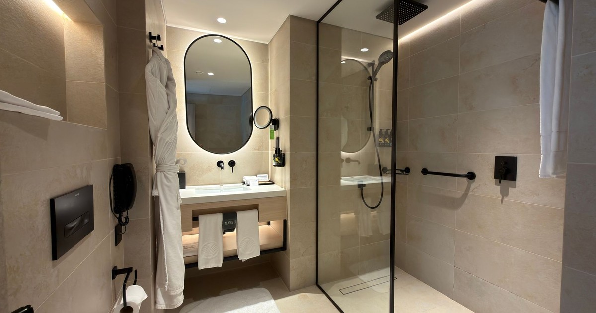 Luxurious hotel bathroom featuring a sleek shower and contemporary fixtures.