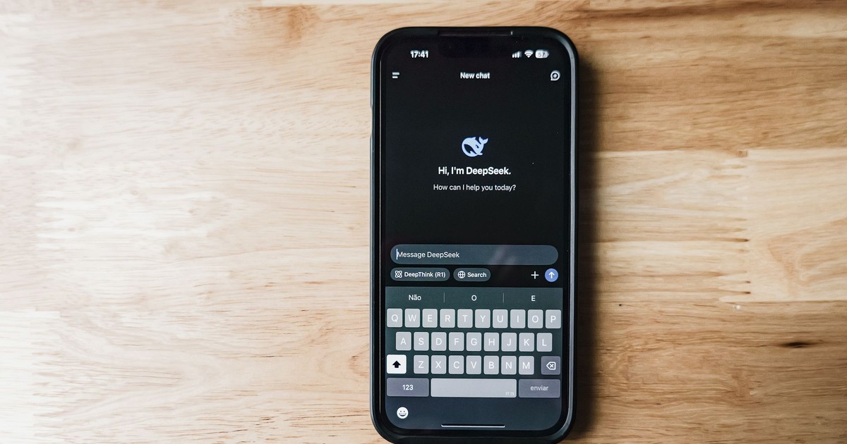 A smartphone on a wooden table showing an AI chatbot interface called DeepSeek.