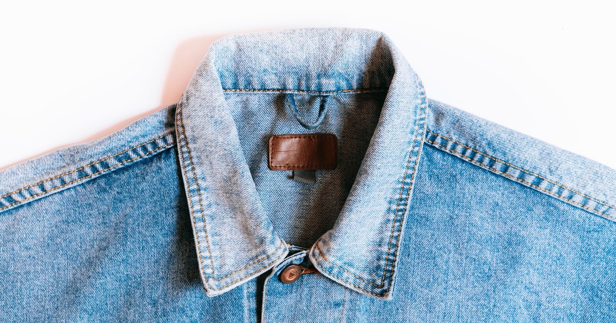 Blue denim jacket collar close-up on a white background, showcasing classic style.
