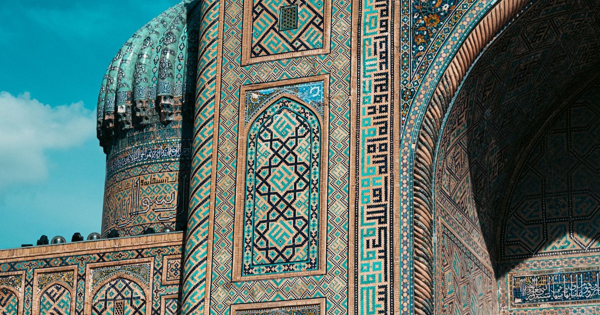 Detailed view of ornate mosaic patterns on Islamic architecture in Uzbekistan, showcasing historic design.