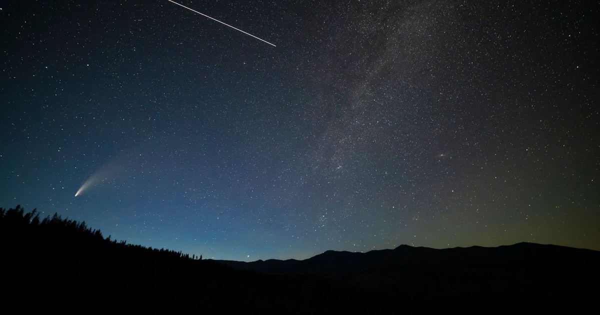 Breathtaking view of a starry sky with comet and shooting star over Entiat, WA.