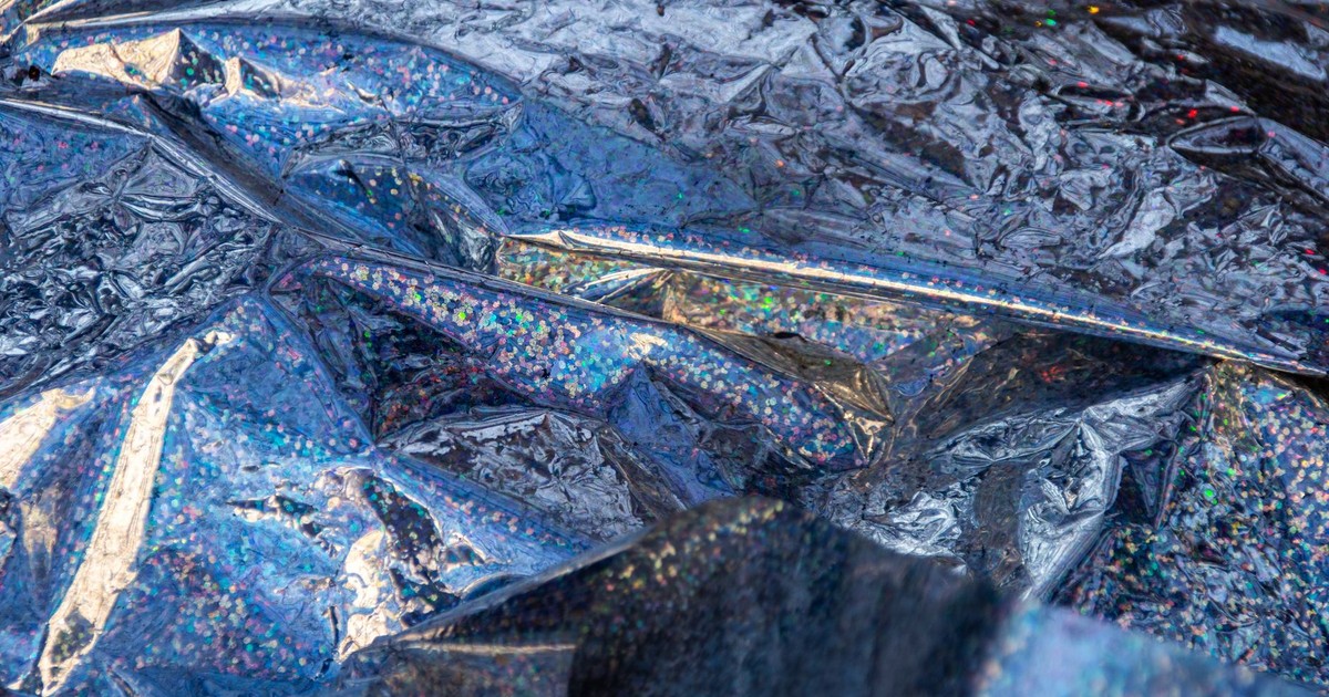 A close-up view of colorful crumpled metallic foil with reflective and sparkling textures.