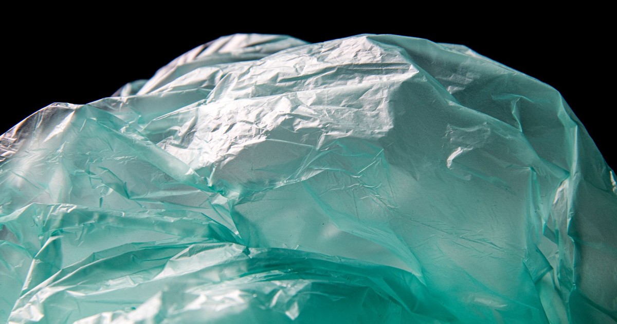 Detailed close-up of crumpled blue plastic against a black backdrop.