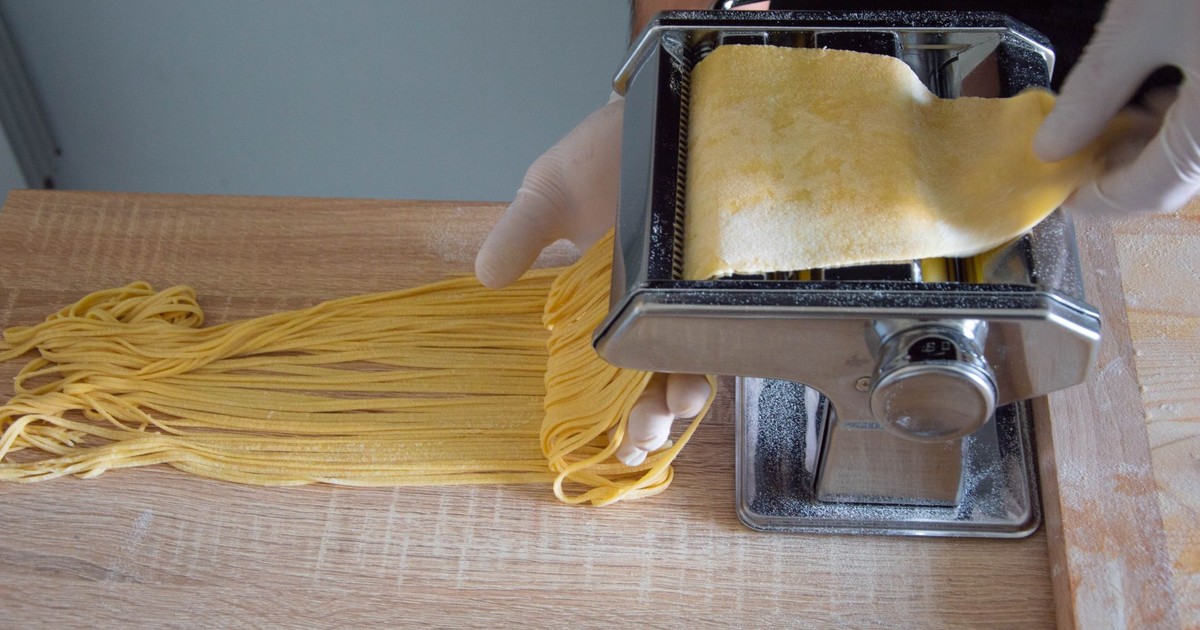 Close-up of pasta maker creating fresh spaghetti in a Roman kitchen.