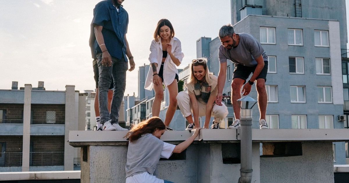 A group of friends enjoying a sunny day on a rooftop, symbolizing fun and friendship.