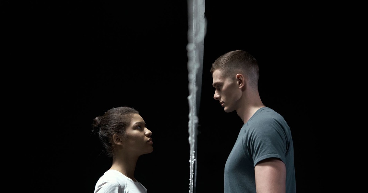 Two people facing each other with a barrier between them, conveying confrontation