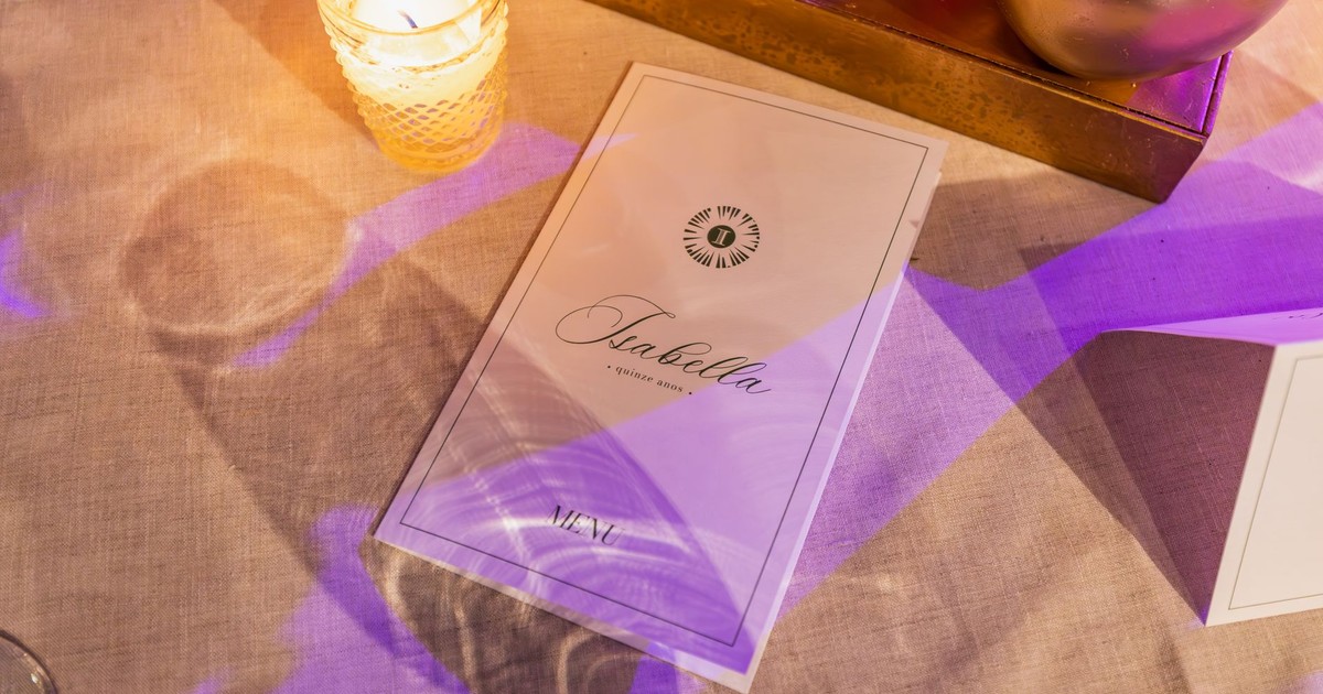 A luxurious restaurant table setup featuring a menu and candlelight for a warm dining experience.