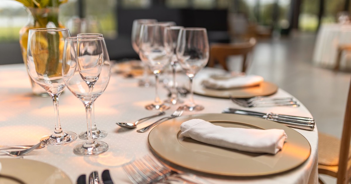 Sophisticated table setup with glassware and napkins for fine dining experience.